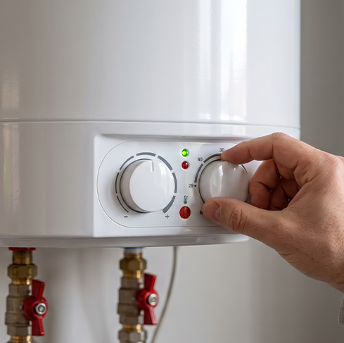 Adjusting the temperature control on a white boiler unit